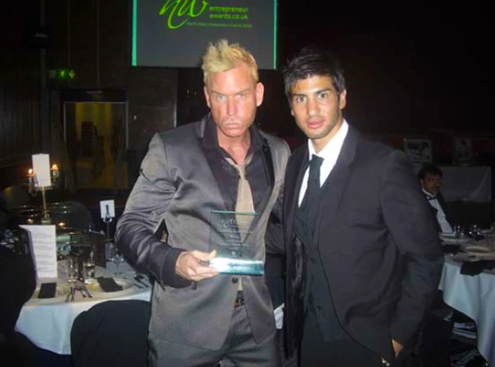 Scott Alexander holding his award at the awards ceremony