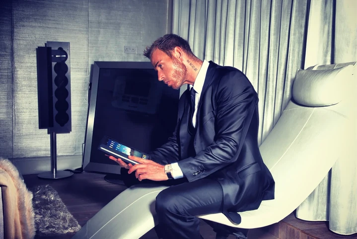 Scott Alexander reading in an armchair